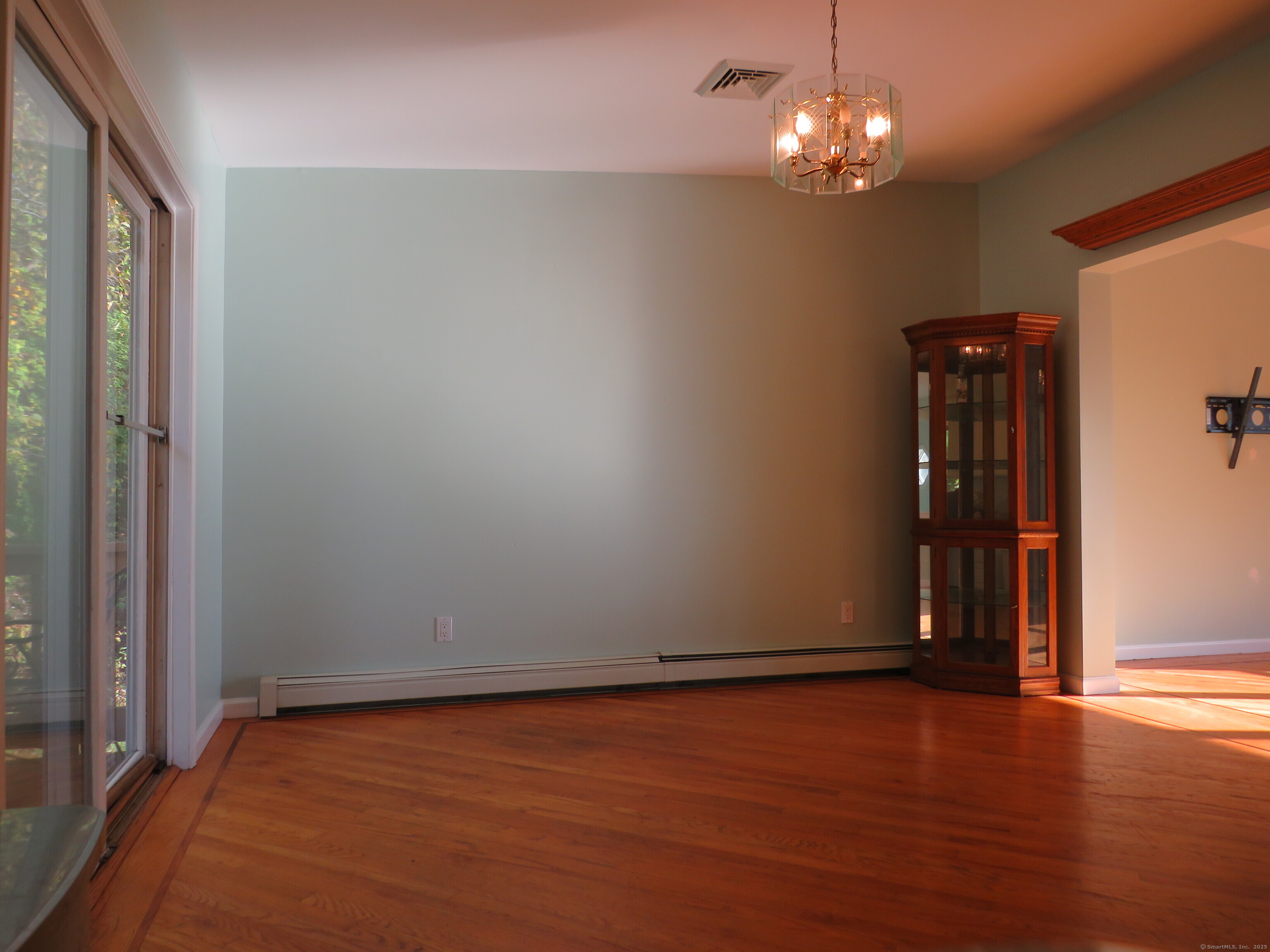 15 Hayestown Heights Danbury, CT 06811 - Photo 8 of 28 a view of an empty room with wooden floor and a window