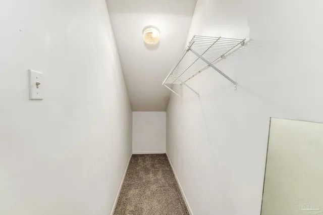 an empty room with wooden floor and mirror