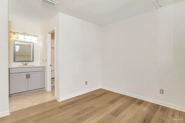a bathroom with a sink mirror and vanity