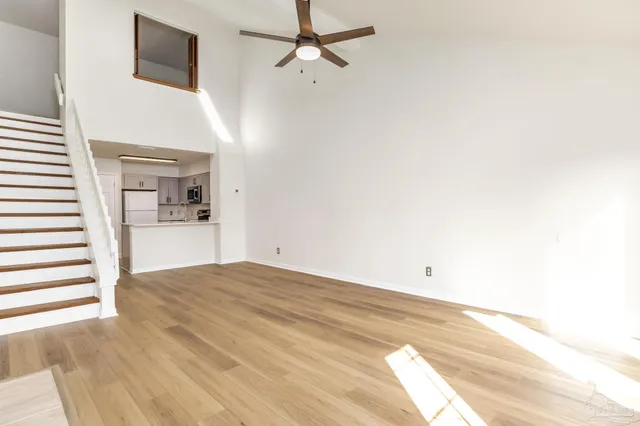a view of a room with wooden floor