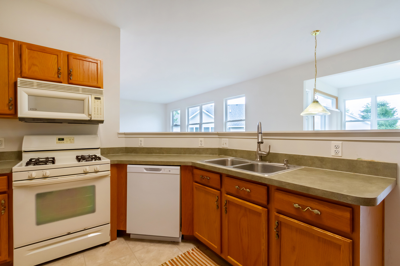 1508 Ludington Circle Romeoville, IL 60446 - Photo 7 of 28 a kitchen with a sink stove and microwave