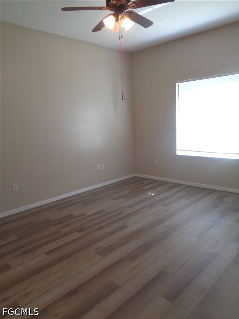 2463 Nature Pointe Loop Fort Myers, FL 33905 - Photo 21 of 50 an empty room with wooden floor and windows