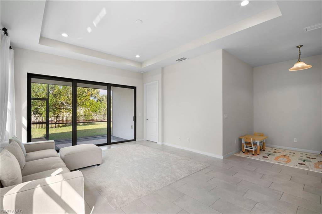 14720 Kingfisher Loop Naples, FL 34120 - Photo 9 of 50 Living room featuring a raised ceiling and recessed lighting