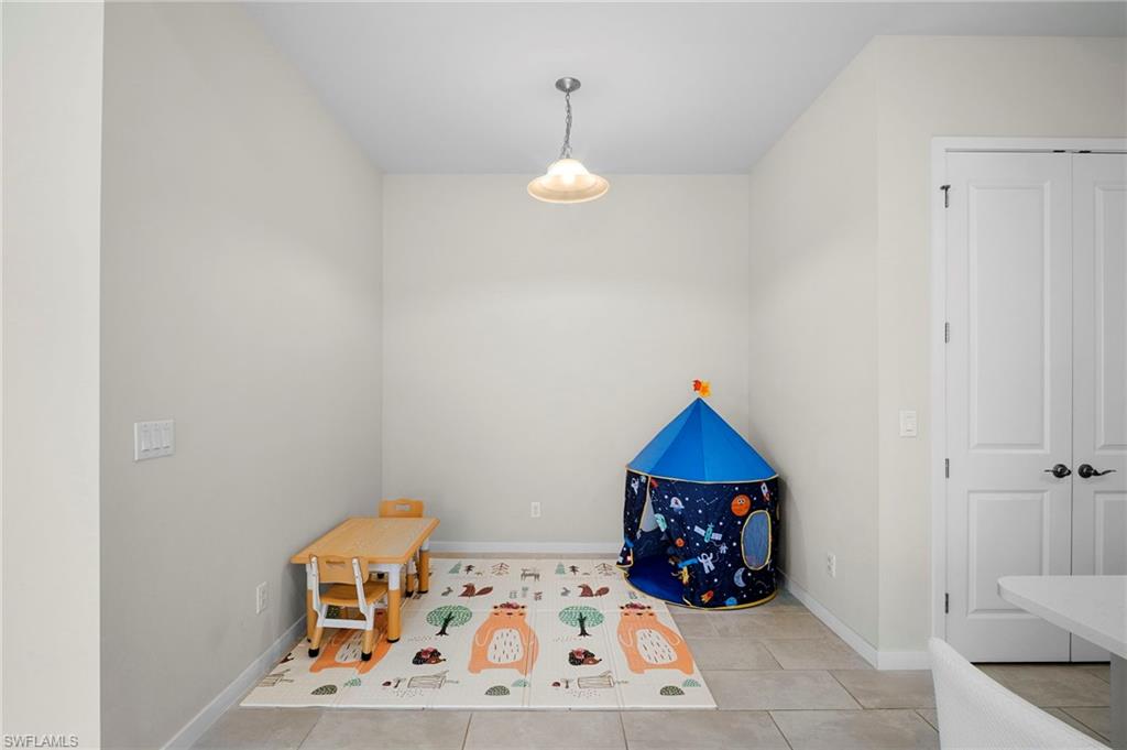 14720 Kingfisher Loop Naples, FL 34120 - Photo 12 of 50 Game room with baseboards and light tile patterned floors