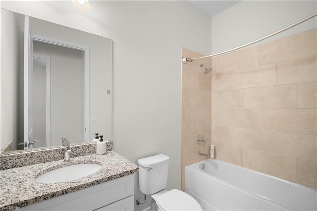 14720 Kingfisher Loop Naples, FL 34120 - Photo 21 of 50 Bathroom with vanity and bathtub / shower combination