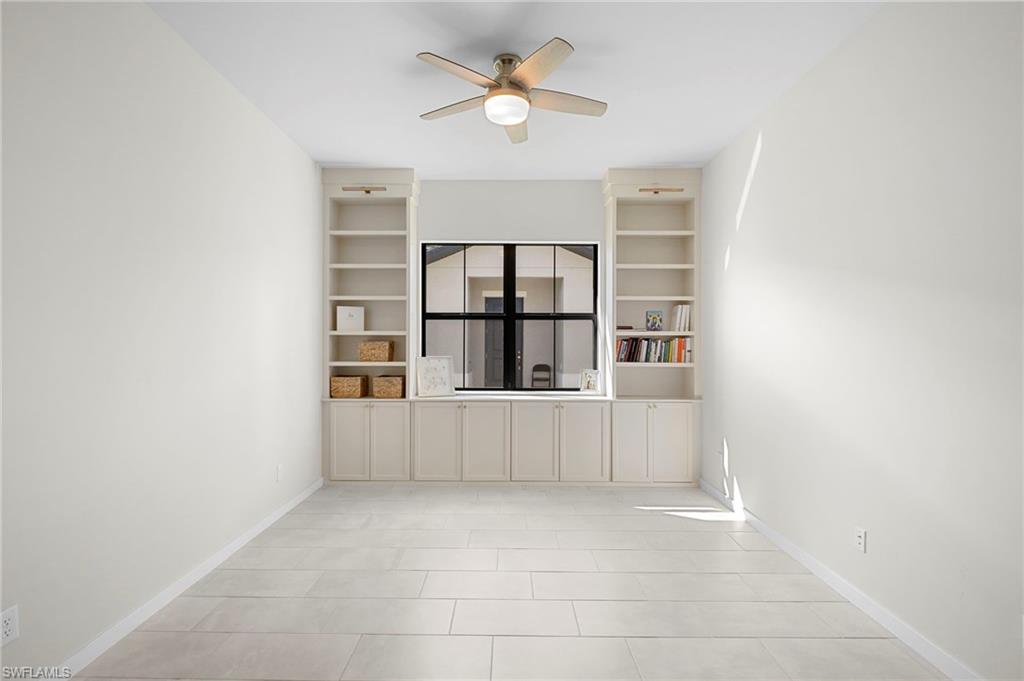 14720 Kingfisher Loop Naples, FL 34120 - Photo 23 of 50 Empty room featuring ceiling fan and built in features