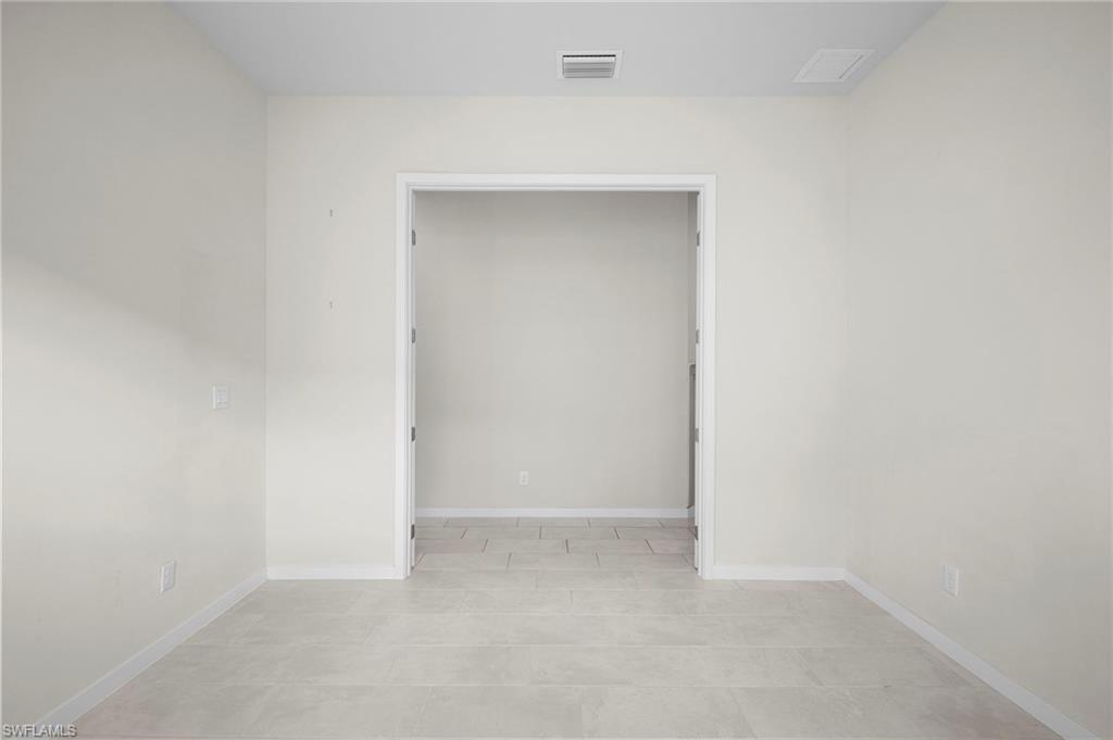 14720 Kingfisher Loop Naples, FL 34120 - Photo 24 of 50 Spare room featuring baseboards