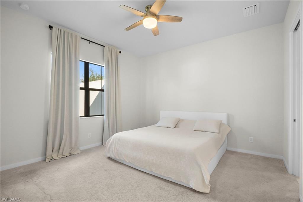 14720 Kingfisher Loop Naples, FL 34120 - Photo 25 of 50 Bedroom featuring ceiling fan and light colored carpet