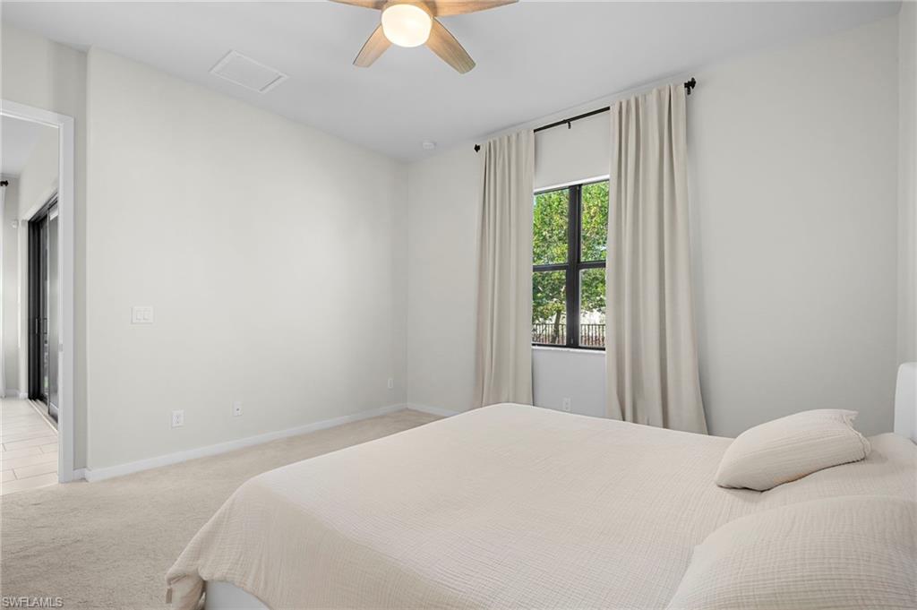 14720 Kingfisher Loop Naples, FL 34120 - Photo 27 of 50 Bedroom featuring light colored carpet and a ceiling fan