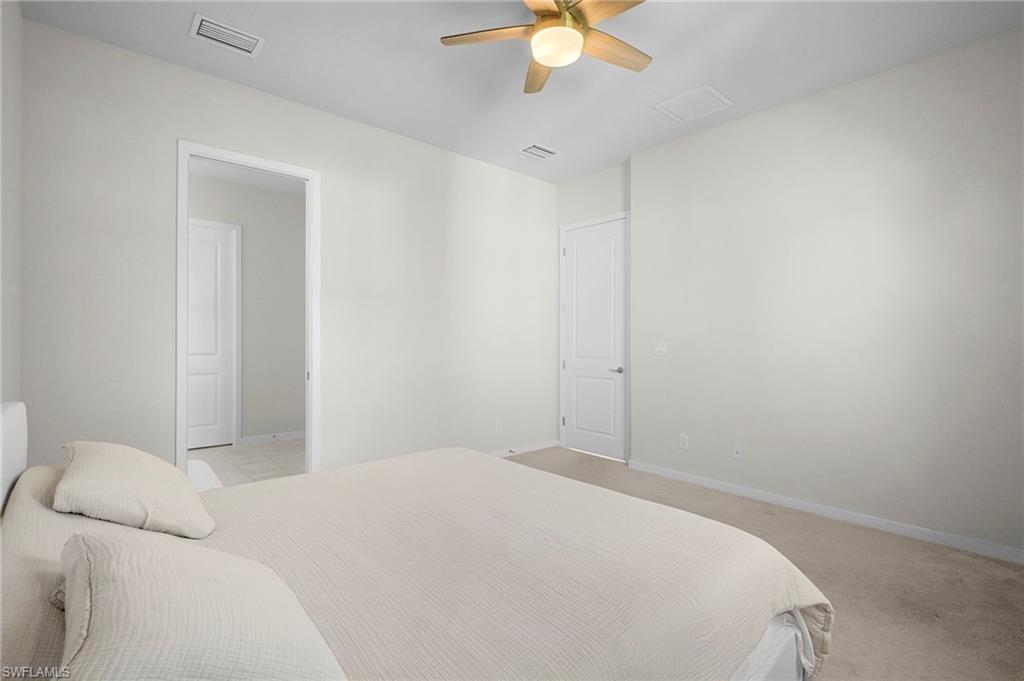 14720 Kingfisher Loop Naples, FL 34120 - Photo 28 of 50 Bedroom featuring ceiling fan and light carpet