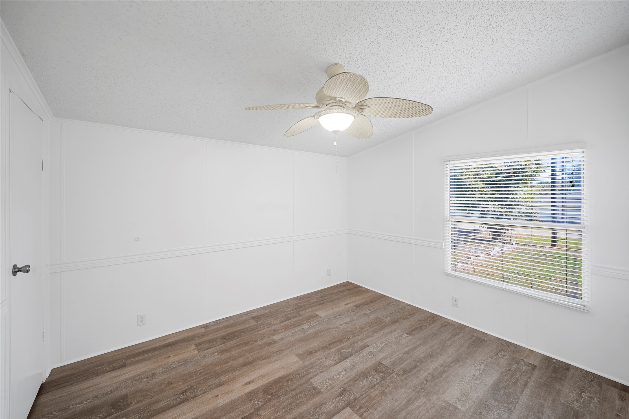 3614 College Street Damon, TX 77430 - Photo 13 of 15 a view of an empty room with wooden floor and a window