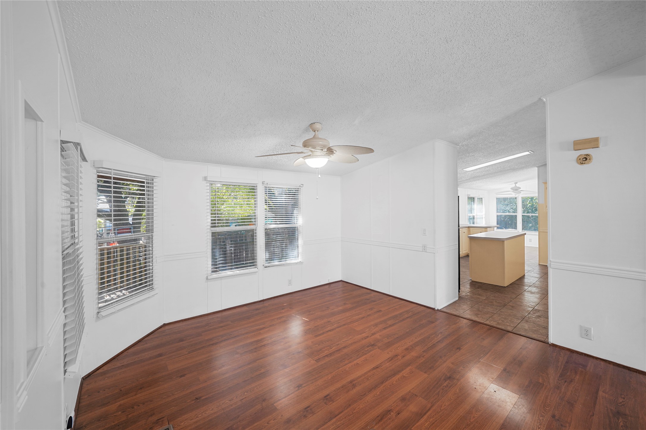 3614 College Street Damon, TX 77430 - Photo 5 of 15 a view of empty room with wooden floor and fan