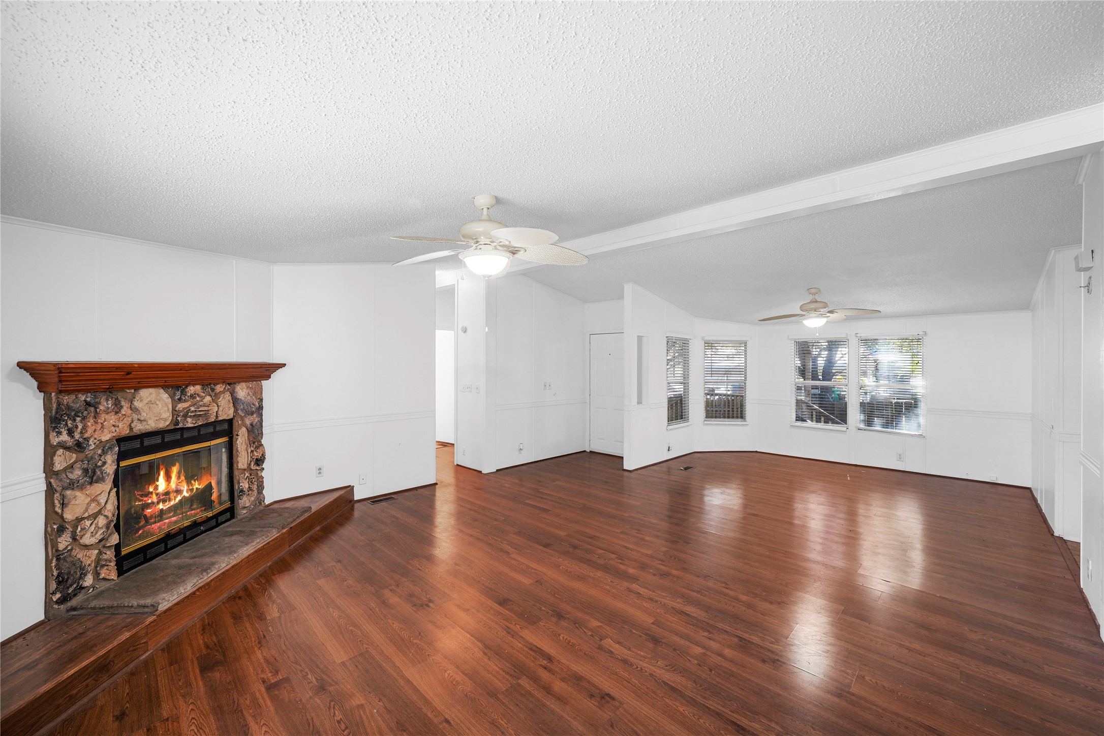 3614 College Street Damon, TX 77430 - Photo 6 of 15 an empty room with windows and fireplace