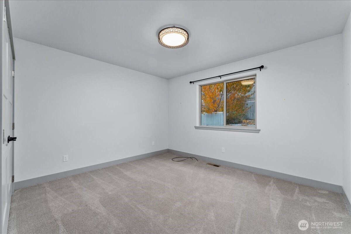 9978 Saska Way Entiat, WA 98822 - Photo 11 of 35 a view of an empty room with a window and closet area