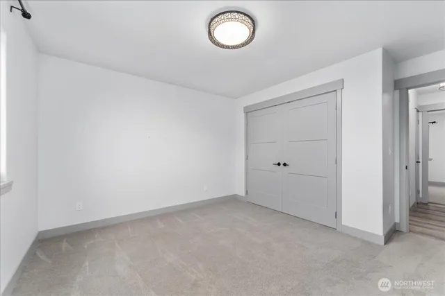 an empty room with a cabinet and mirror