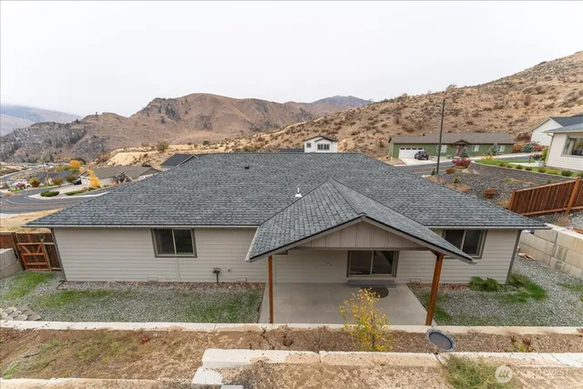 a aerial view of a house next to a yard