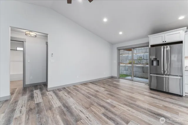 a view of empty room with wooden floor and window