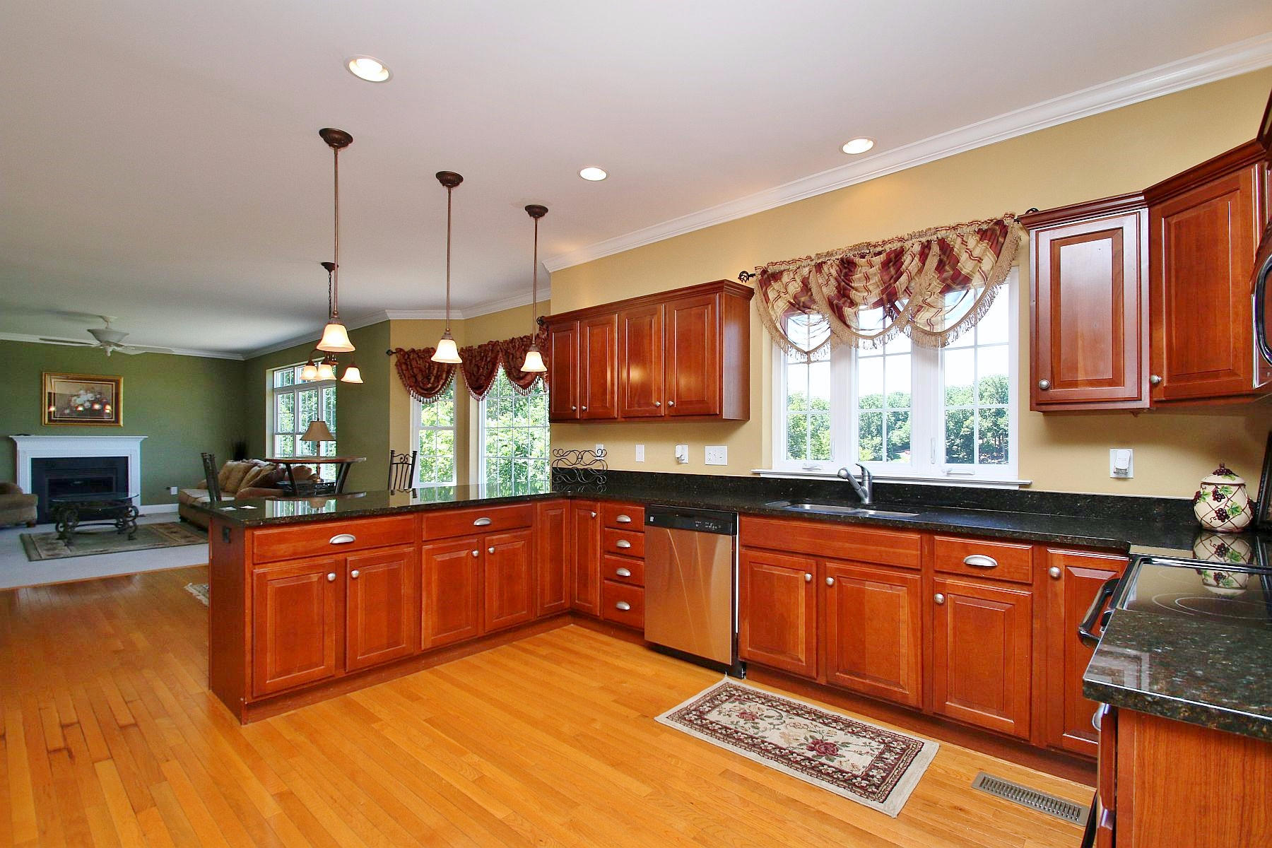 10 Old Point Road Moneta, VA 24121 - Photo 19 of 79 a large kitchen with stainless steel appliances granite countertop a sink dishwasher a stove and a dining table with wooden floor