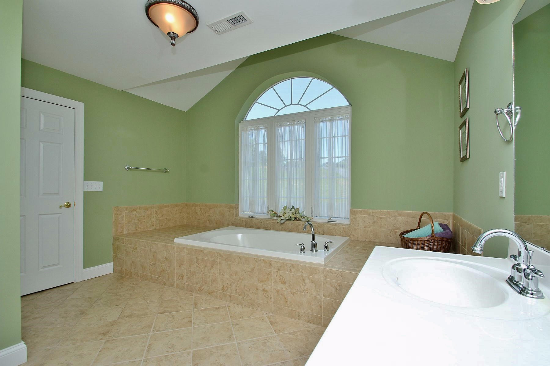 10 Old Point Road Moneta, VA 24121 - Photo 39 of 79 a bathroom with a tub sink and mirror