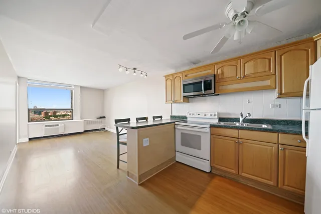 a kitchen with a sink cabinets and appliances
