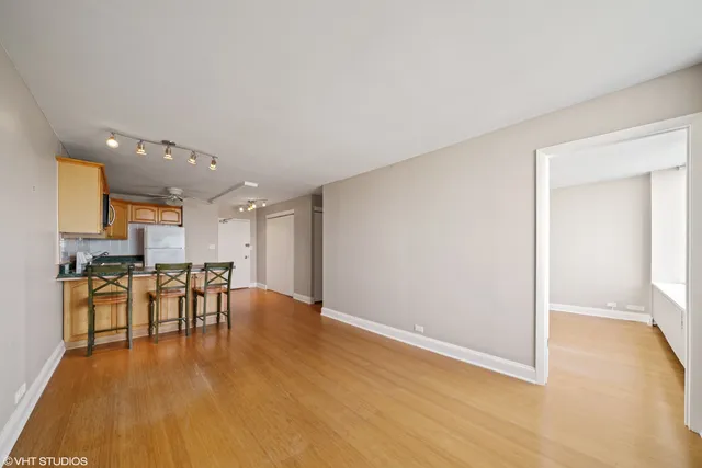 a view of a kitchen with dining table and chairs