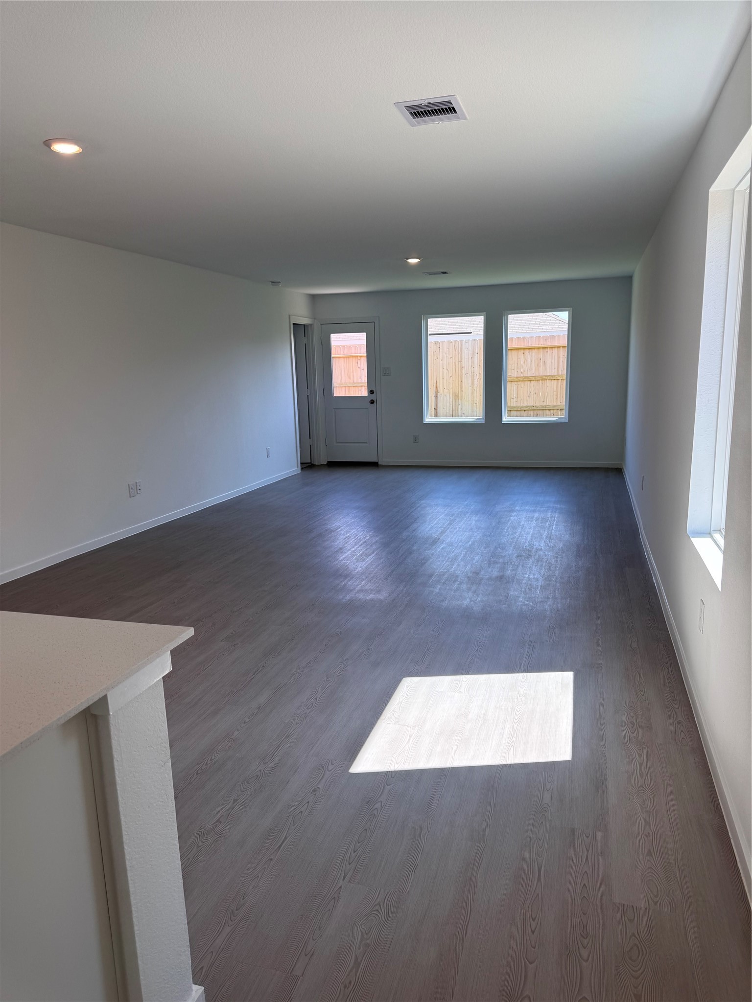 6150 Cherry Ripe Lane Katy, TX 77493 - Photo 9 of 19 an empty room with wooden floor and windows