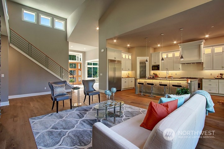 3123 234th Street Southeast Bothell, WA 98021 - Photo 2 of 26 a living room with furniture kitchen view and a dining table