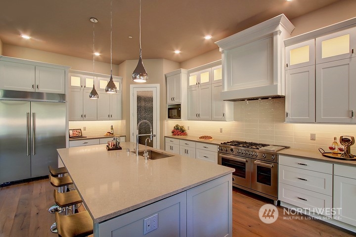 3123 234th Street Southeast Bothell, WA 98021 - Photo 3 of 26 a kitchen with stainless steel appliances granite countertop a sink stove and refrigerator