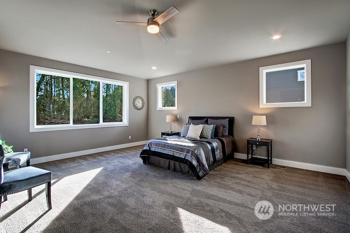 3123 234th Street Southeast Bothell, WA 98021 - Photo 5 of 26 a spacious bedroom with a bed and a window