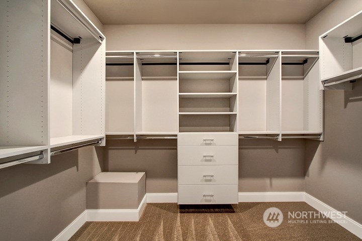 3123 234th Street Southeast Bothell, WA 98021 - Photo 7 of 26 a view of walk in closet with clothes and shoes