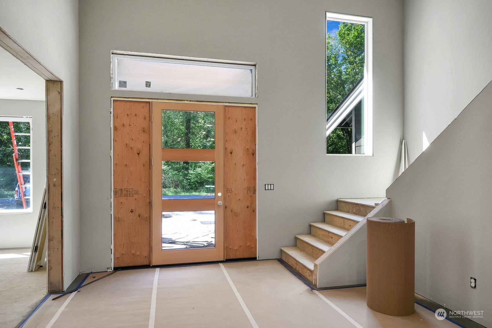 3123 234th Street Southeast Bothell, WA 98021 - Photo 9 of 26 a view of an empty room with wooden floor and windows