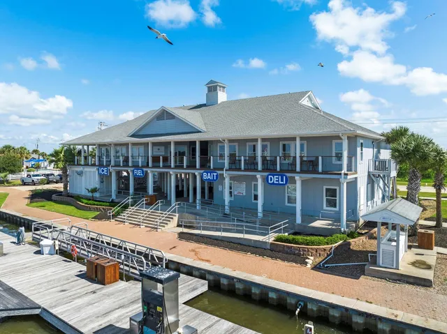 a view of a house with pool and chairs