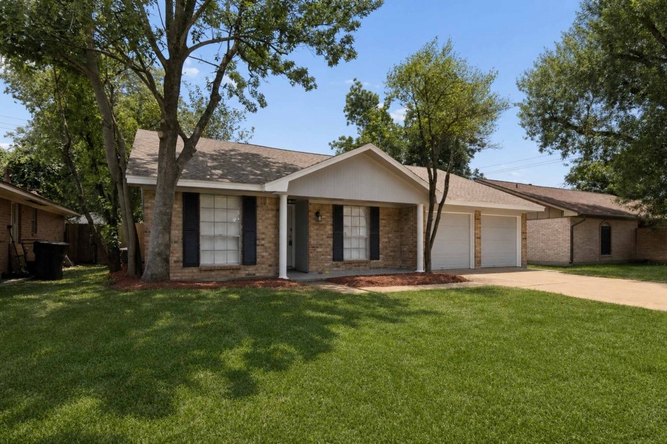 7403 Strawbridge Lane Houston, TX 77040 - Photo 2 of 22 a big house with a big yard and large trees