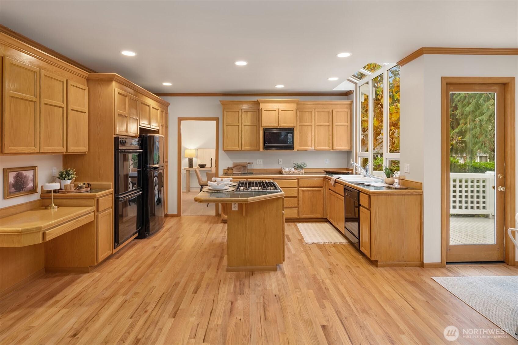 3014 213th Street Southeast Bothell, WA 98021 - Photo 11 of 33 a large kitchen with stainless steel appliances granite countertop a stove top oven a sink dishwasher a refrigerator and white cabinets with wooden floor