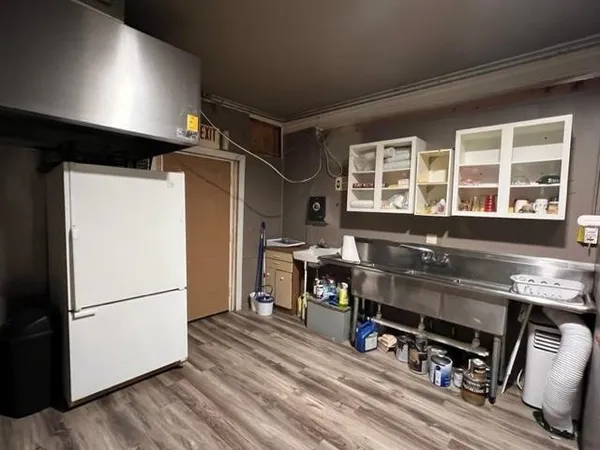 a kitchen with stainless steel appliances granite countertop a refrigerator and a stove