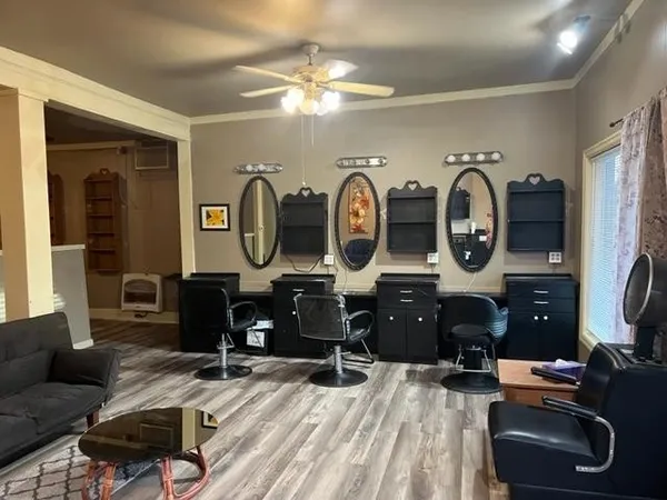 a living room with furniture a mirror and a flat screen tv