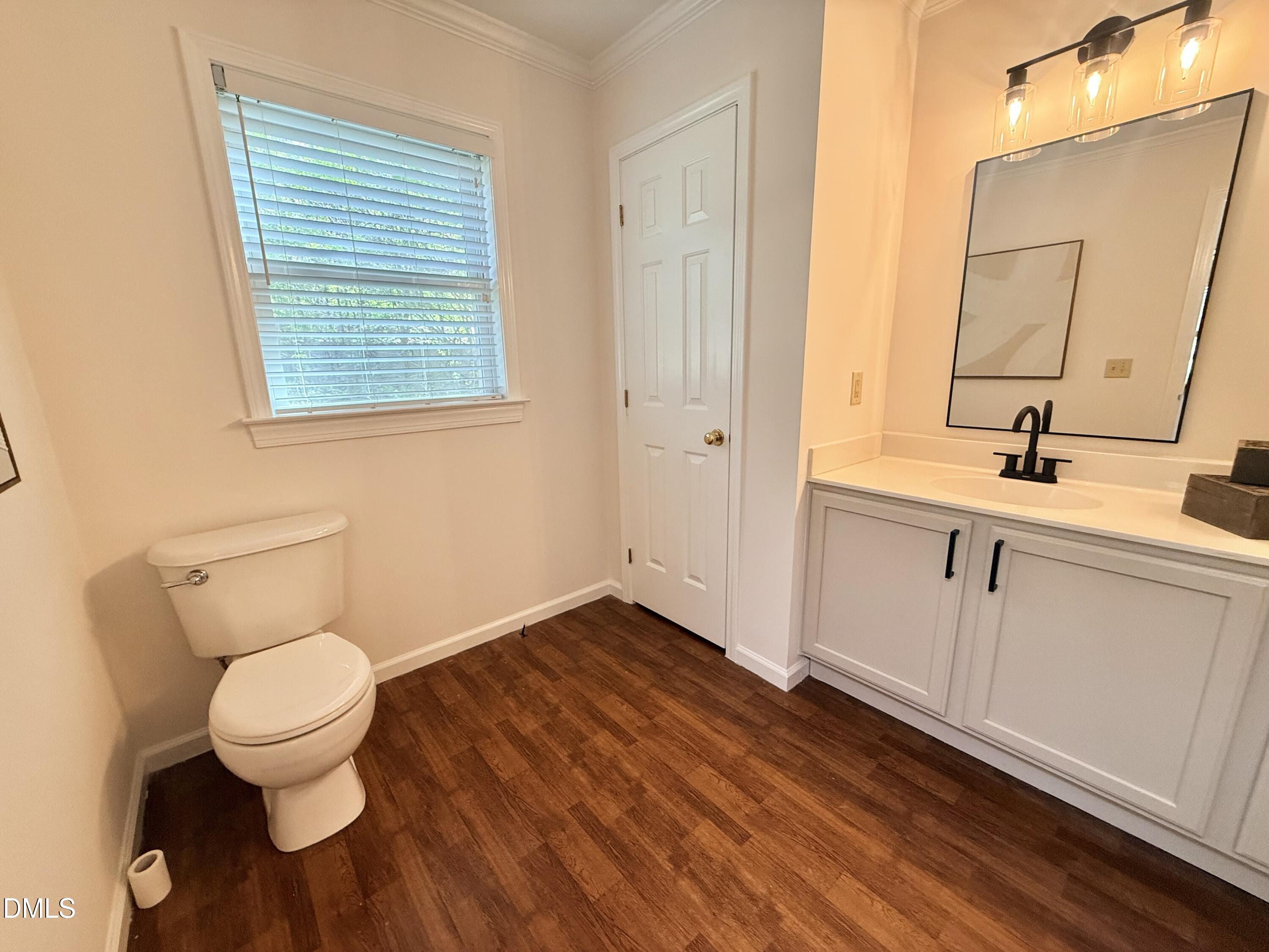2429 Halifax Road Roxboro, NC 27573 - Photo 37 of 54 a bathroom with a toilet sink and mirror