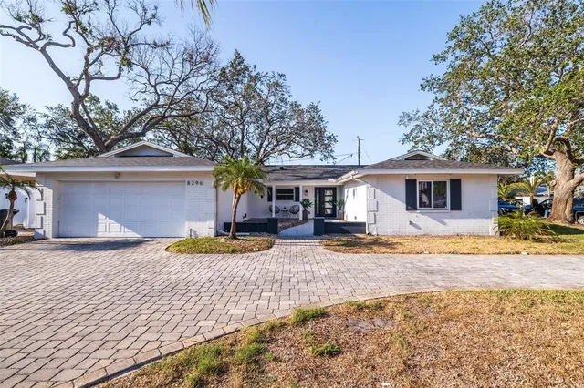 a front view of a house with a yard and a garage