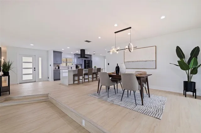 a view of a dining room kitchen with furniture and a potted plant