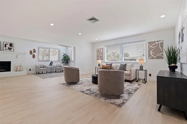 a living room with furniture a window and a flat screen tv