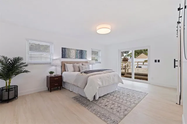 a spacious bedroom with a large bed and a rug