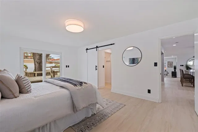 a bedroom with a large bed and a chandelier