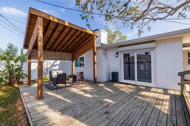 a view of a house with backyard porch and sitting area
