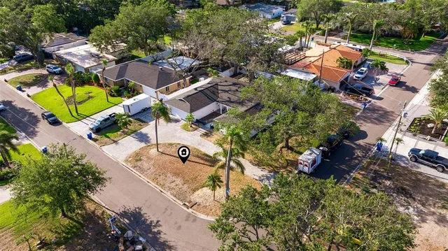 an aerial view of a house with a garden and swimming pool
