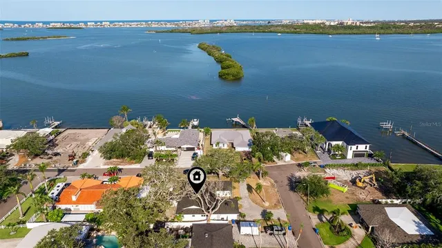 an aerial view of a house with a lake view
