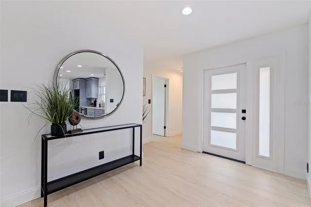 wooden floor with a potted plant on a dresser and a wooden floor
