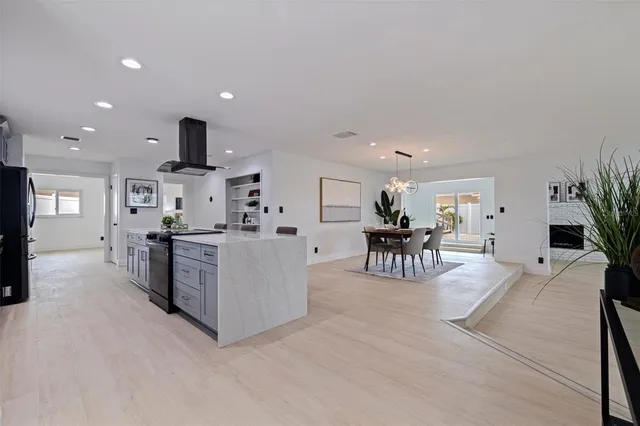 a living room with furniture and kitchen view