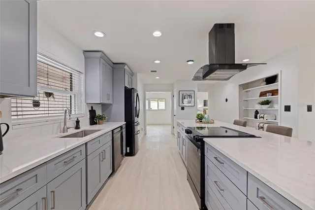 a kitchen with stainless steel appliances a sink stove and cabinets