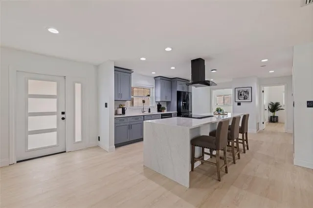 a kitchen with kitchen island wooden cabinets and stainless steel appliances