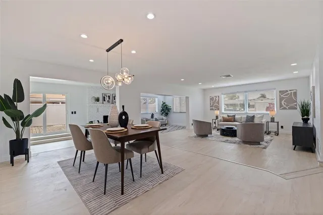 a view of a dining room with furniture and chandelier